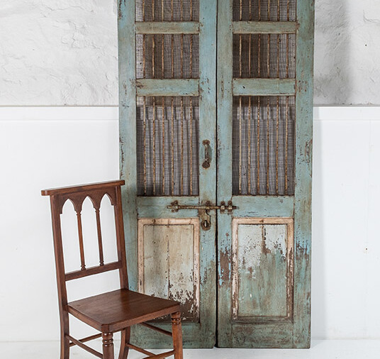 A decorative pair of very old solid teak French Chateau shutter mesh doors with original ironmongery